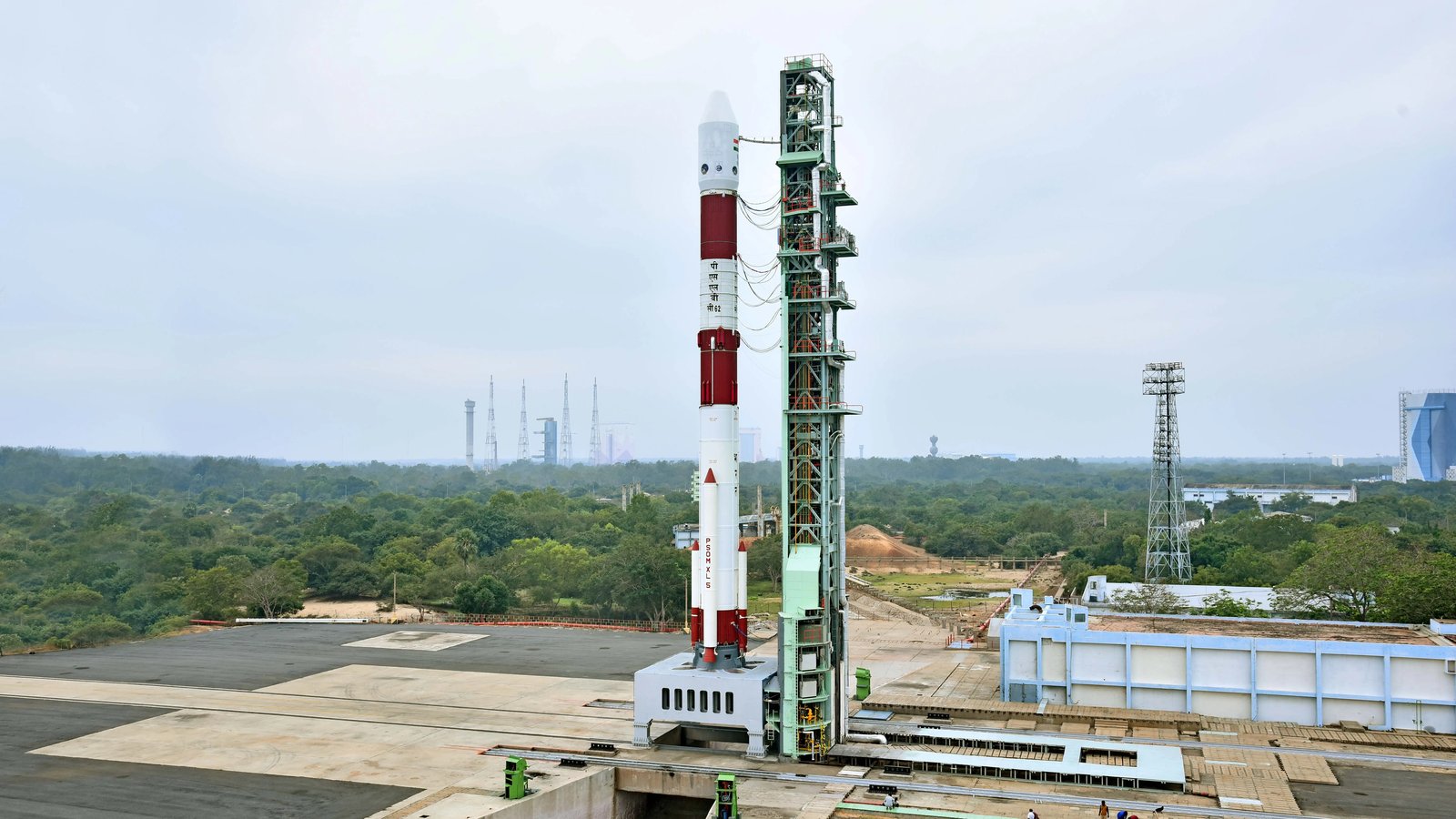 A PSLV rocket standing on the First Launch Pad at Sriharikota beside its tall service tower