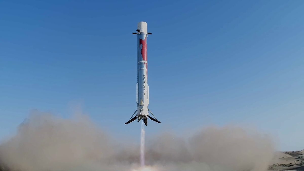 The Zhuque-3 first stage descending on a column of flame with its four landing legs out, just above a cloud of desert dust